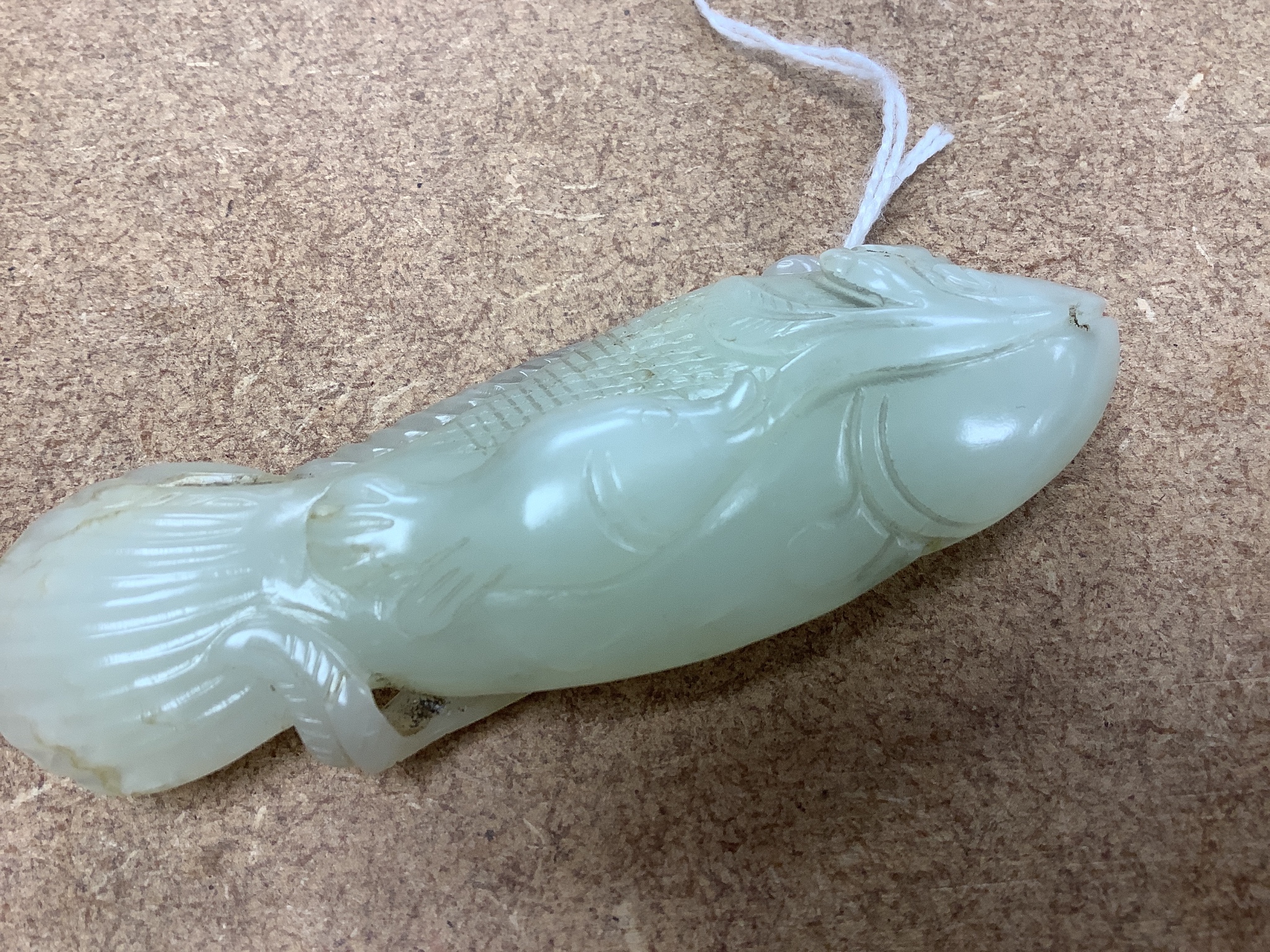 A Chinese pale celadon jade carving of a fish, 8.7 cm